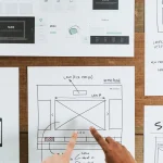 Hands pointing to a design document