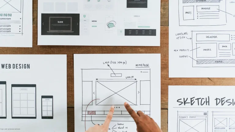 Hands pointing to a design document