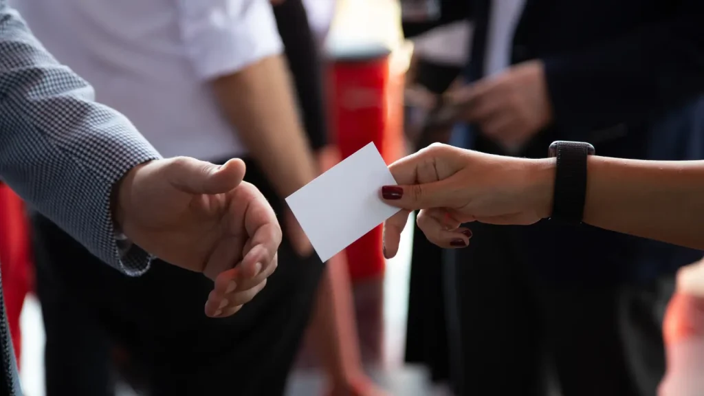 Woman handing a business card to someone