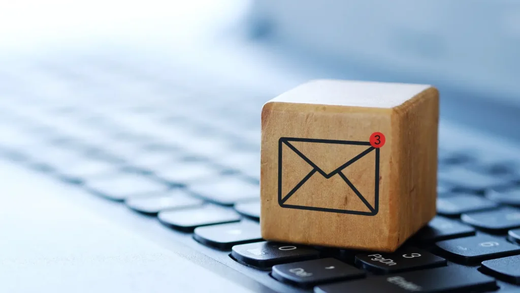 Email icon on a wooden cube