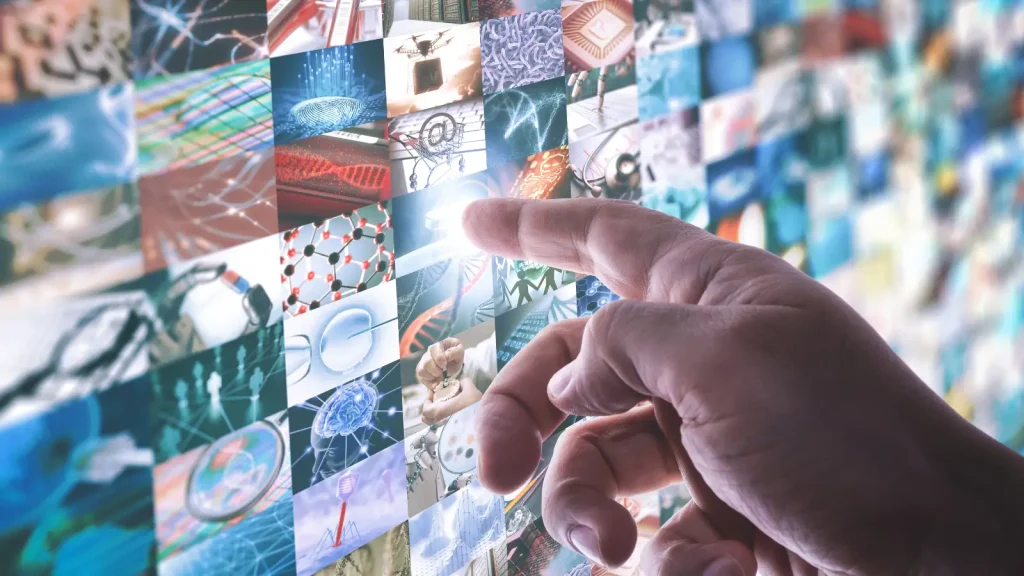 Finger pointing to a screen of science and technology images 