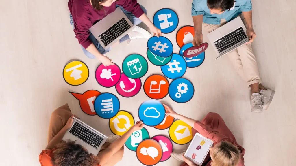 People holding social media icons in a circle 