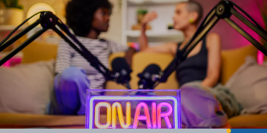 Neon on air sign standing on a table in a studio while recording podcast