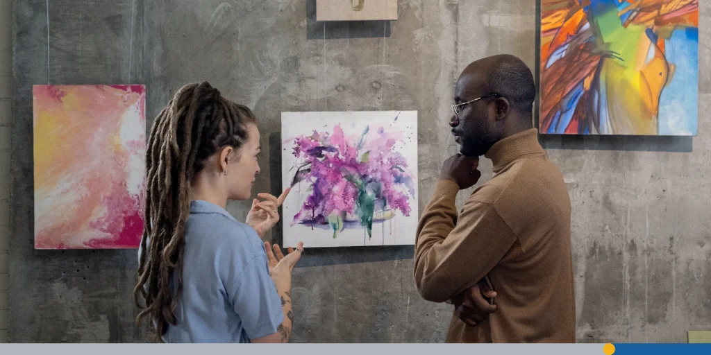 Couple discussing modern art in studio
