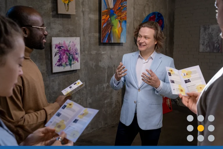 Happy artist interacting with guests of exhibition of his artworks