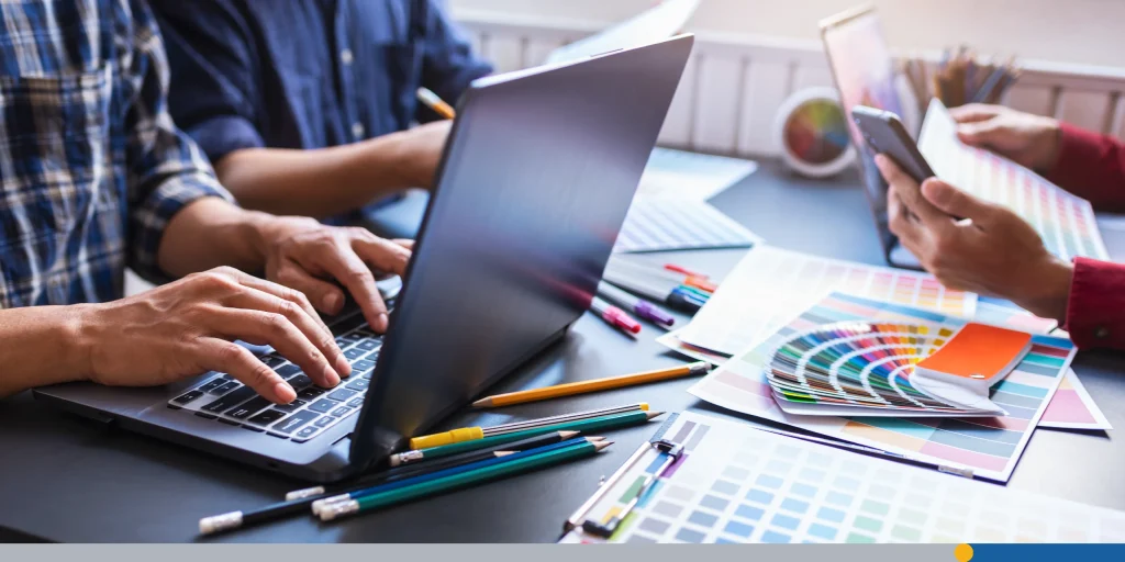 People working on how to create a logo in Photoshop on their laptop