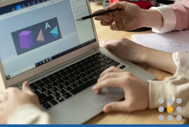 Hands of creative designers by laptop display with sketch of geometric figures