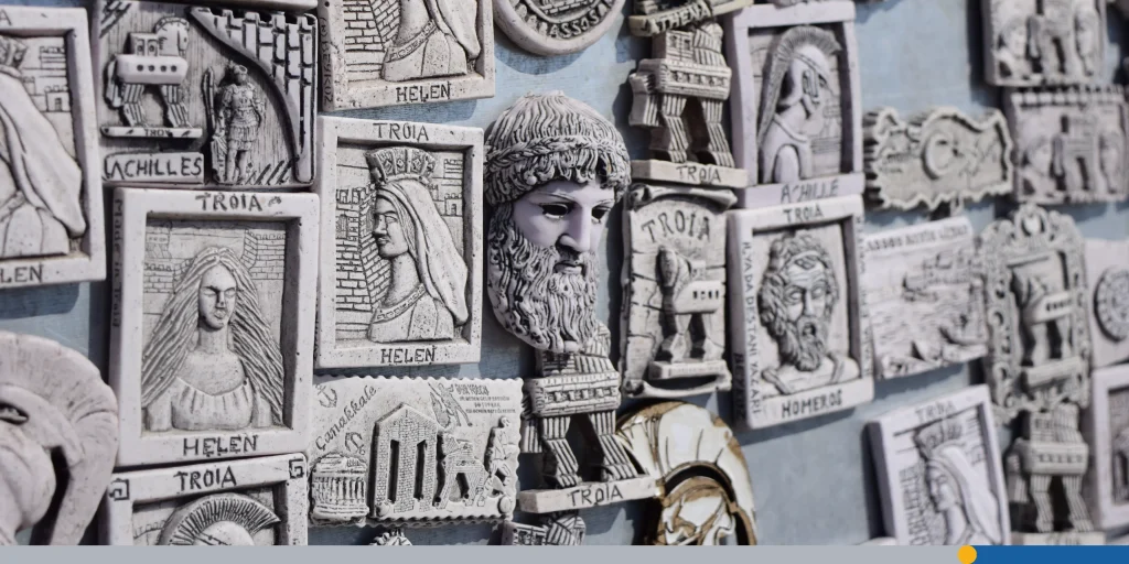 Selective shot of small sculpted images about Greece and Greek gods mounted on the wall