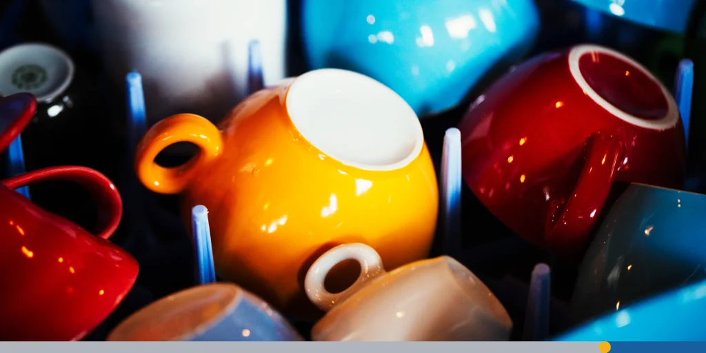 Colorful custom mugs being washed