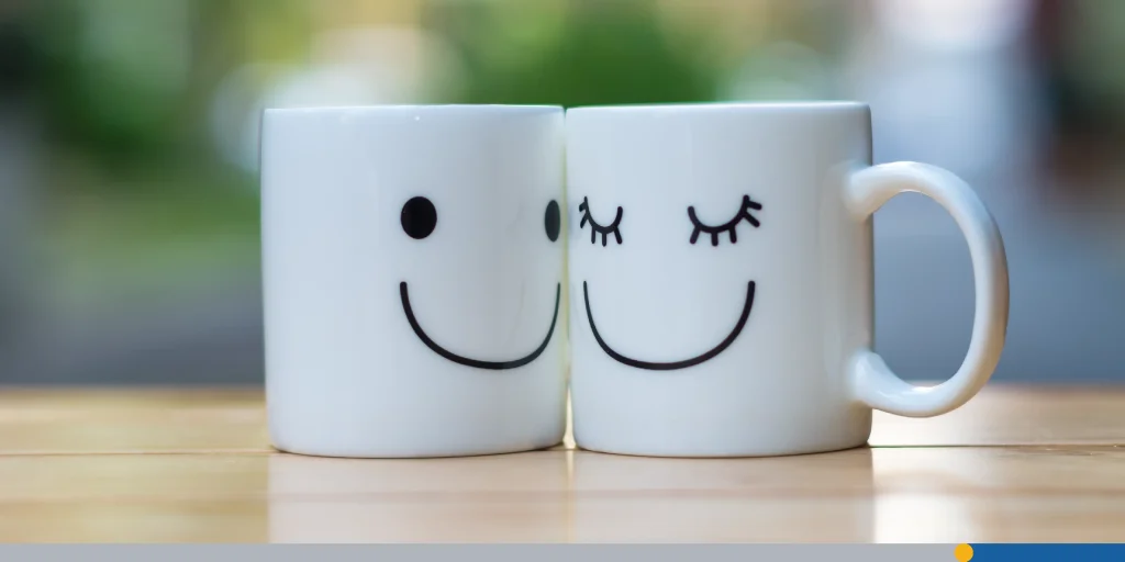 Two happy cups on wood table