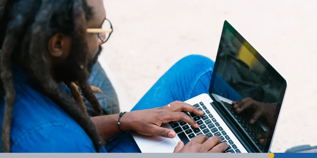 Man working on a laptop outdoors