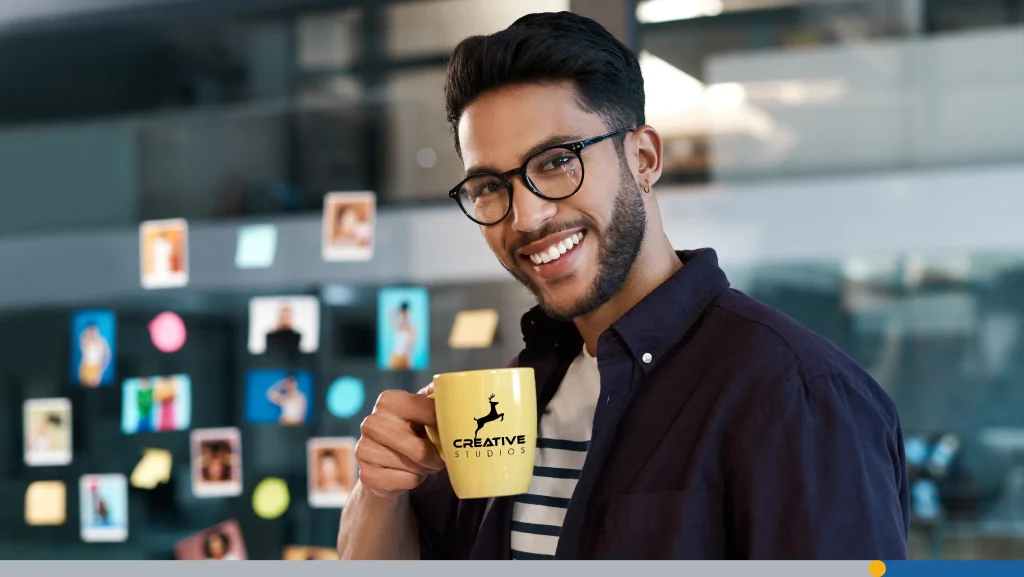 Man with glasses holding a coffee mug