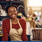 Woman working as florist at flower shop and looking at camera