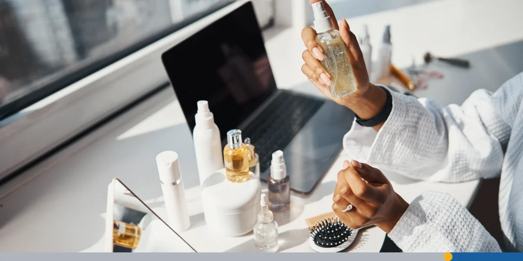 Female hands holding bottle of serum or essential oil 