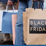 Close up of couple holding Black Friday shopping bags