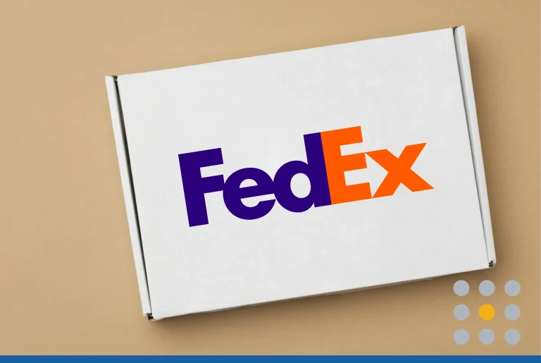 White paper rectangular box on beige background with the FedEx logo on it