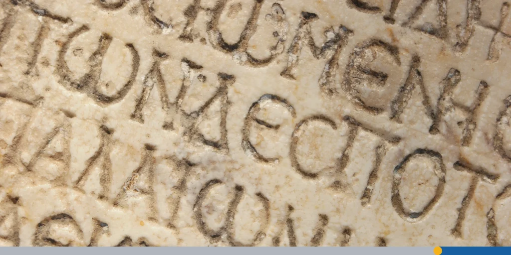 Close up of an ancient text carved on marble