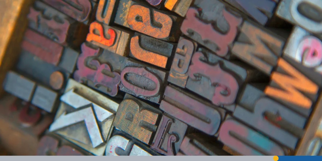 High angle close up of a selection of wood print keys in a variety of fonts