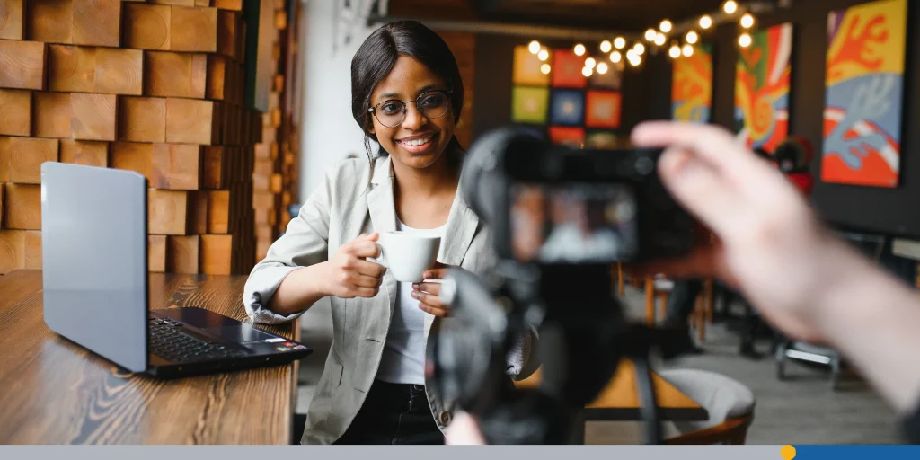 Woman taking a photo with a coffee at a cafe 