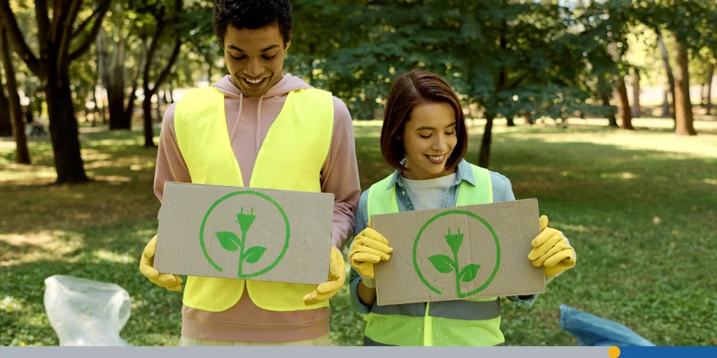 Couple Holding Up Signs In Grass