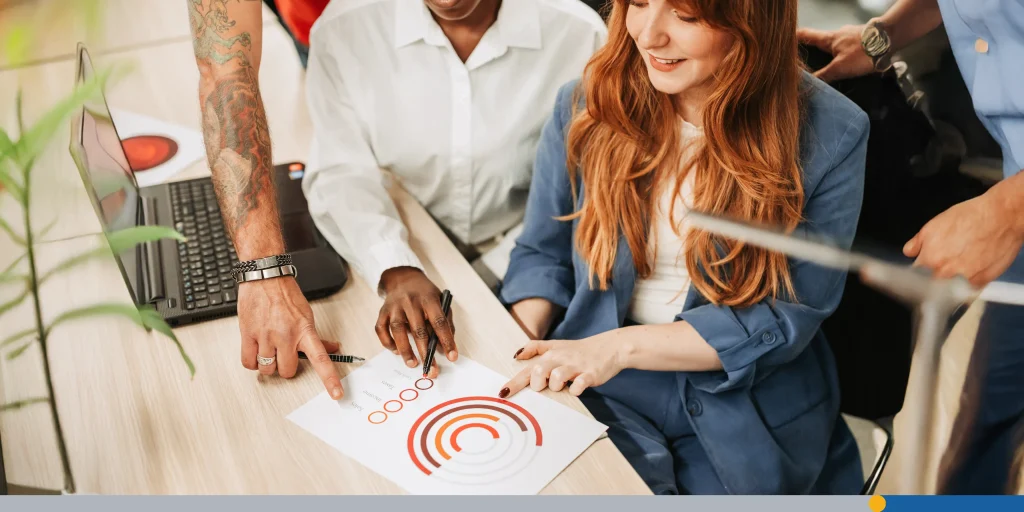 High angle shot of a diverse business team hands pointing on a chart