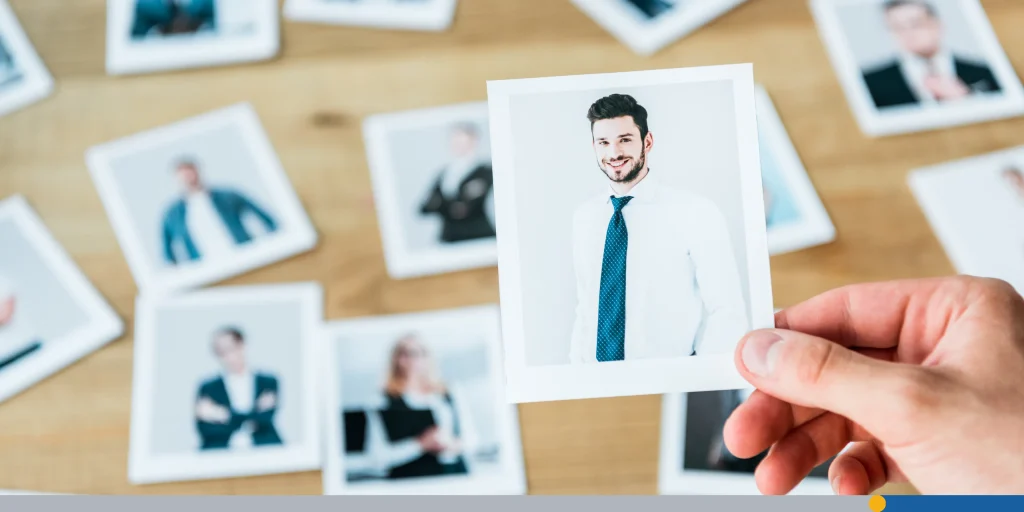 Recruiter holding photo with man in suit
