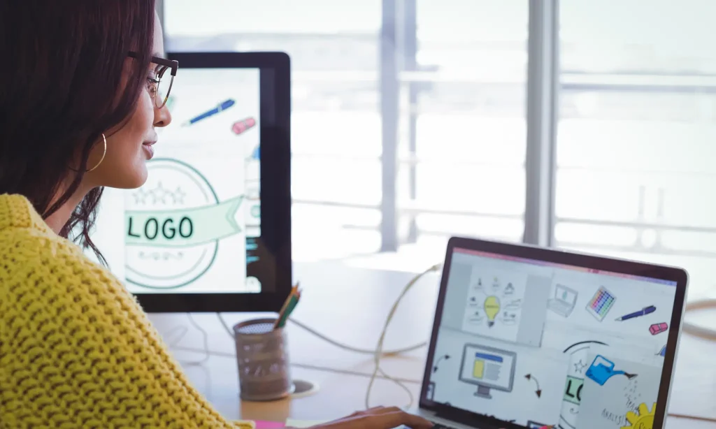 Woman designing a logo on her laptop 