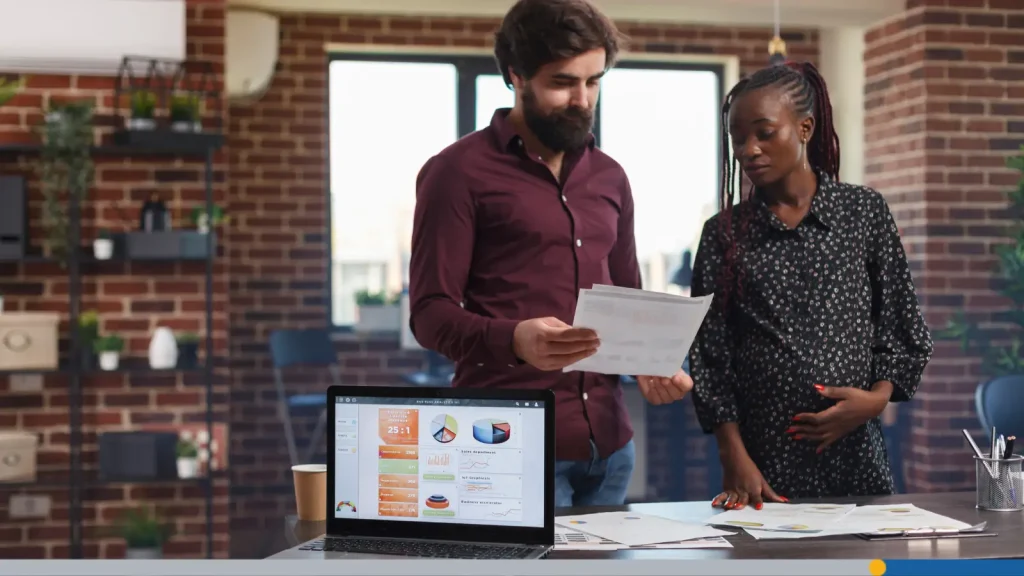 Two people looking at papers in an office