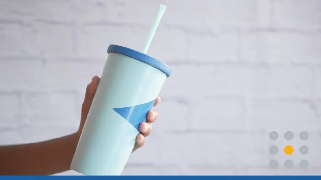 holding a reusable eco coffee cup with copy space.