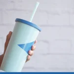 holding a reusable eco coffee cup with copy space.