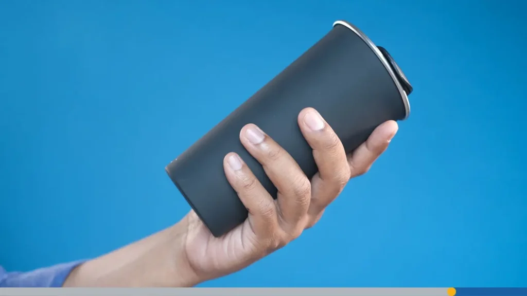 holding black color reusable eco coffee cup.