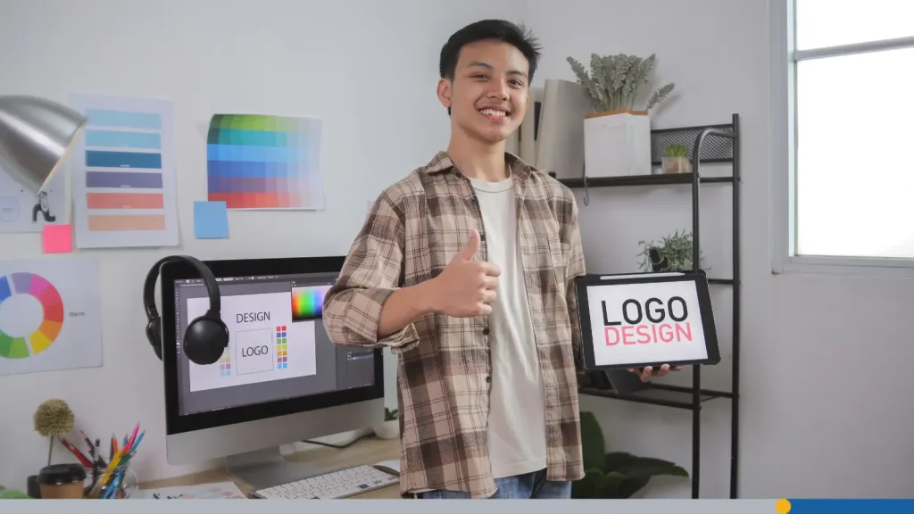 Young man holding a tablet with logo design text on it