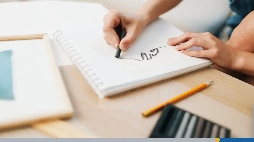 Person drawing a free-hand logo design