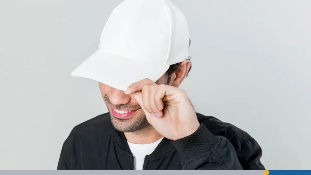 Smiling man wearing a baseball cap