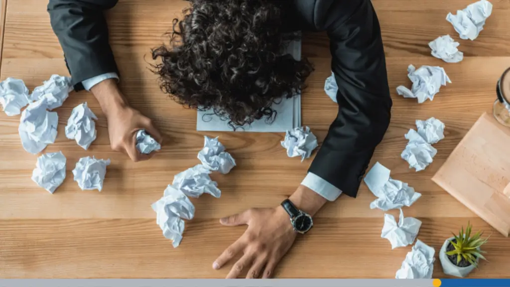 An office worker, exhausted from burnout, has fallen asleep at their desk while trying to manage personalized branding online.