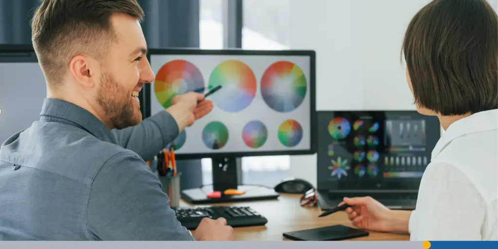 two people using computer color wheels to choose the best color combinations for their business cards.