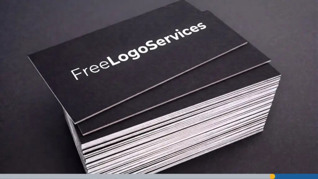 A stack of black custom business cards with white lettering displaying the word FreeLogoServices.