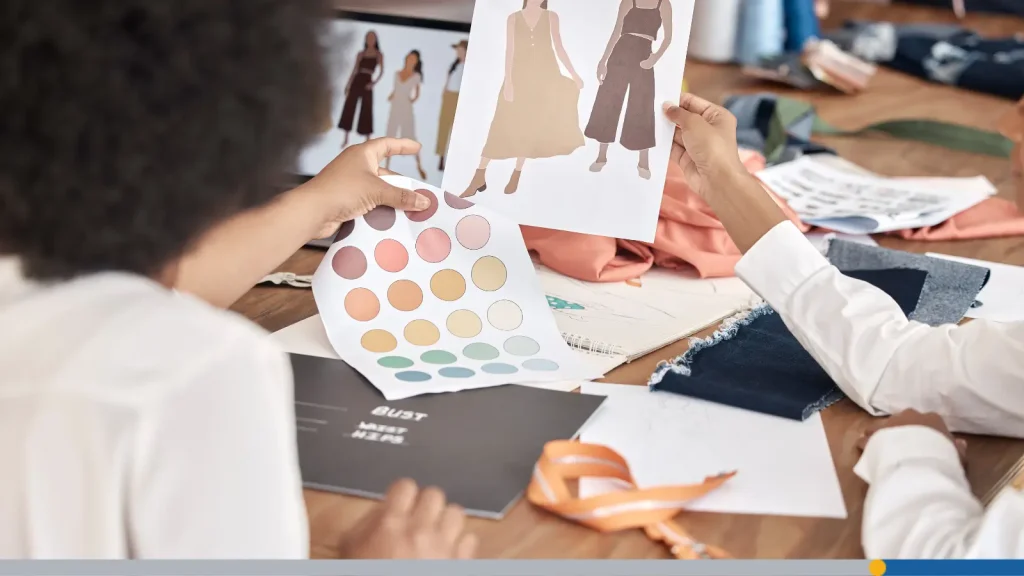 People looking at fashion sketches
