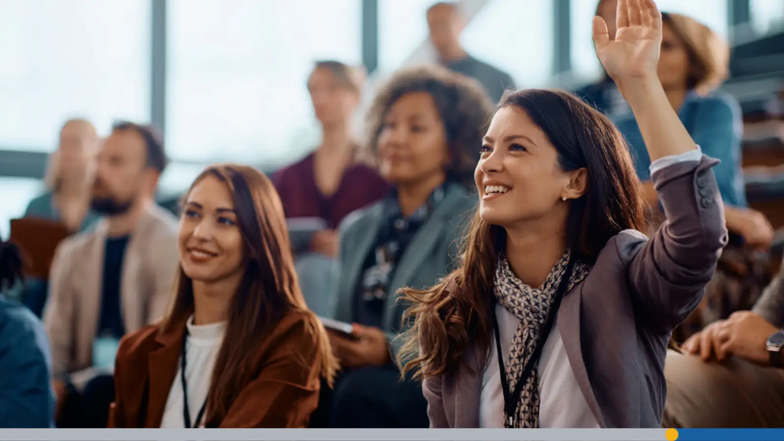 A young woman raising her hand to ask a question about personalized branding.