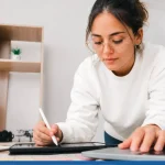 A young woman testing color combinations as she learns to create your own brand.
