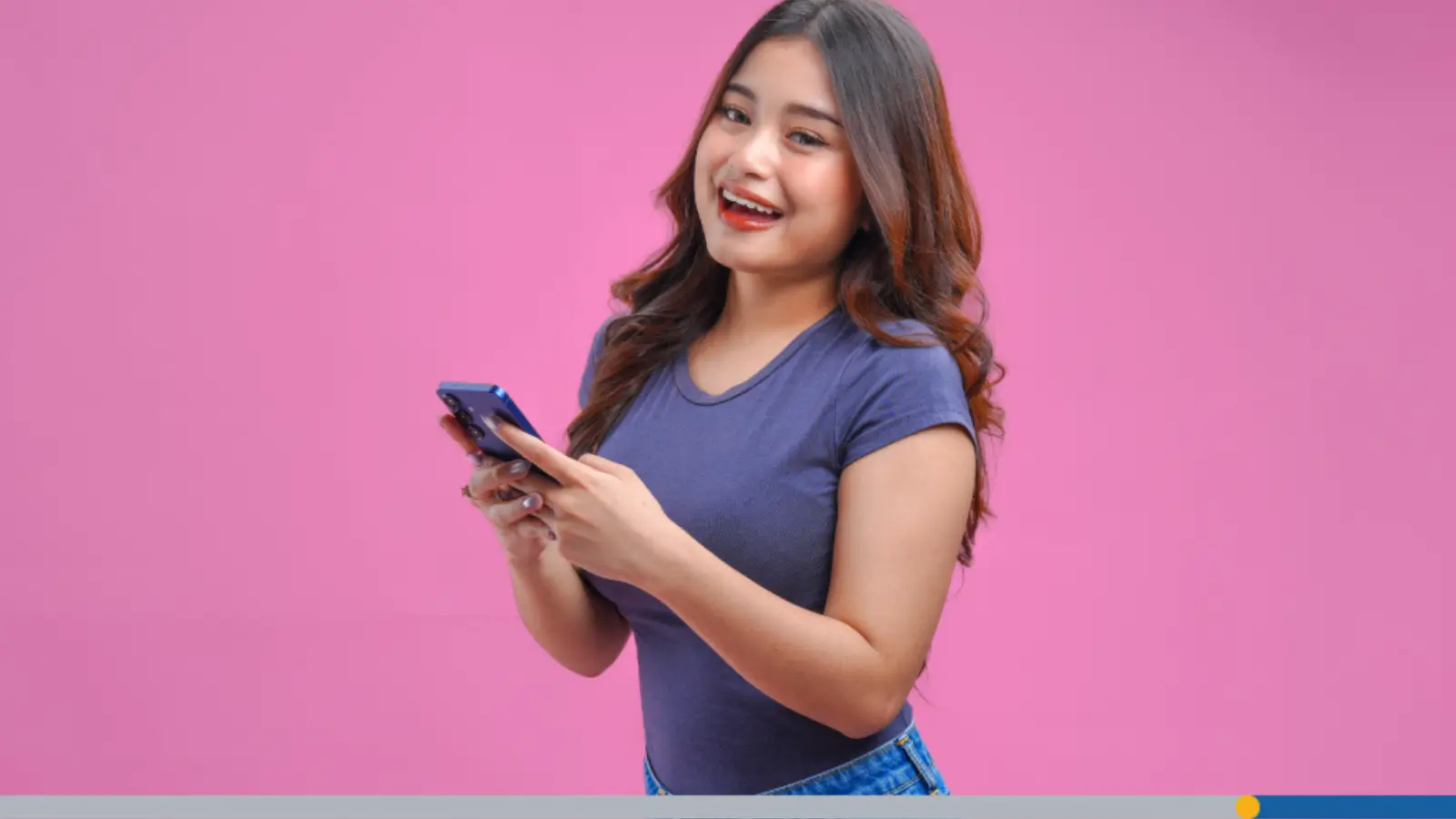 Smiling woman holding a smartphone on a pink background, illustrating the ideal YouTube profile picture size.