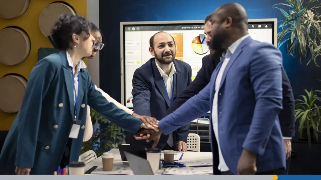 Business people joining their hands to continue their meeting and reach their goals.