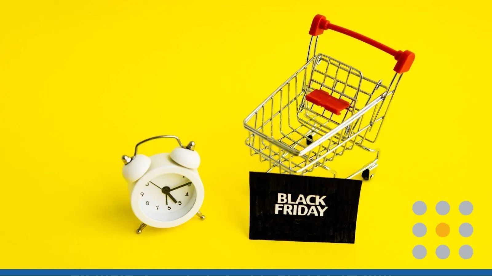 Shopping cart and alarm clock beside a Black Friday bag