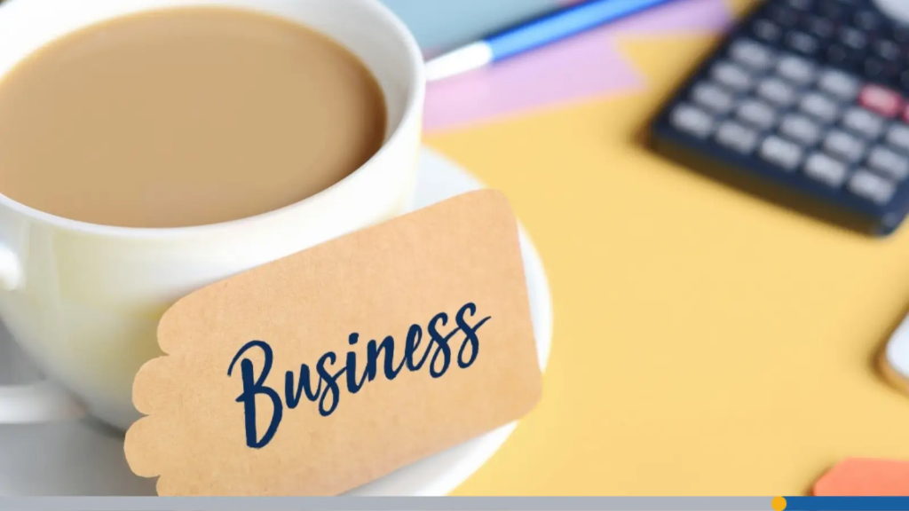 A coffee cup on a saucer next to a tag reading "Business" alongside a calculator and pen, illustrating essential business name tips.