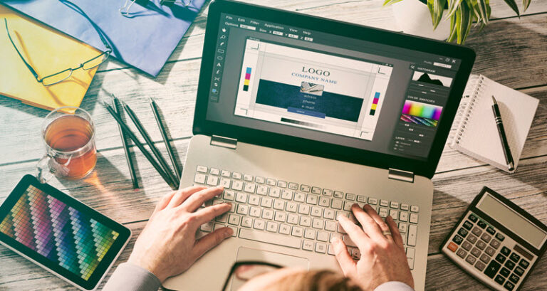 man designing a logo on his laptop