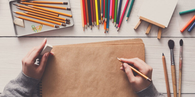 woman drawing on notebook