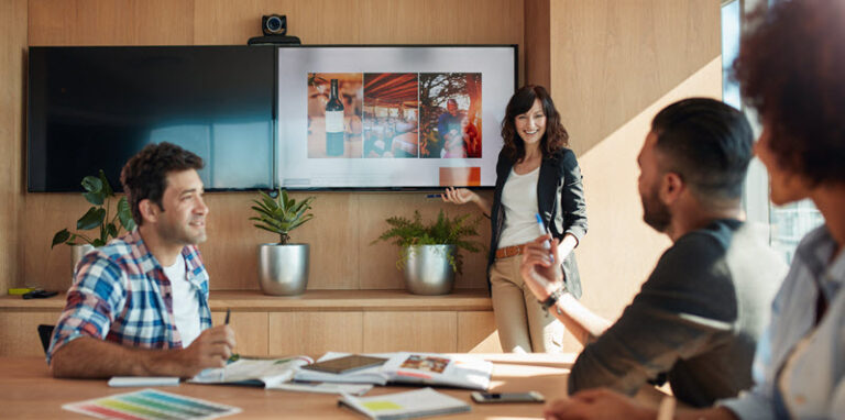 Coworkers pitching ideas in conference room