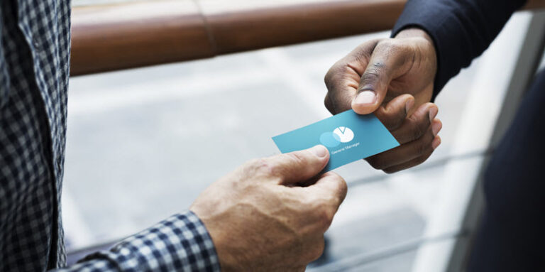 two men exchanging a business card