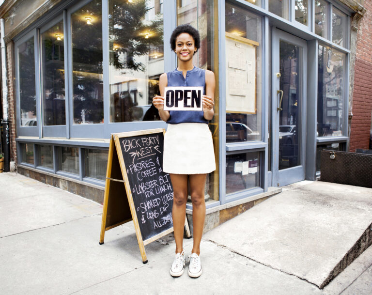 restaurant owner outside promoting her business