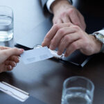 two people exchanging business cards